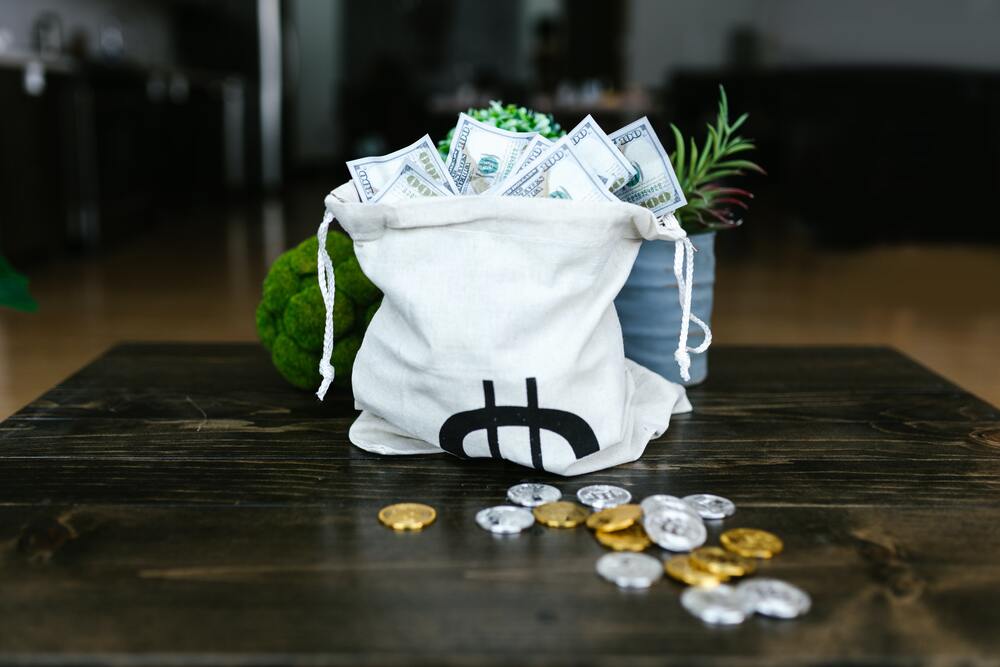 A bag of money and coins on the table