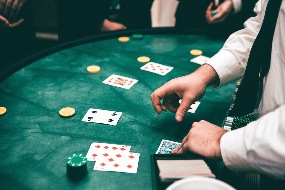 A host dealing the cards in a blackjack table