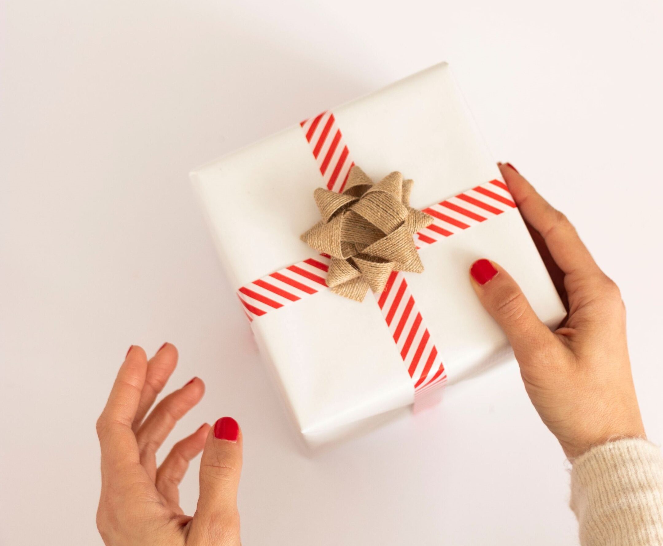 A person holding a wrapped gift.