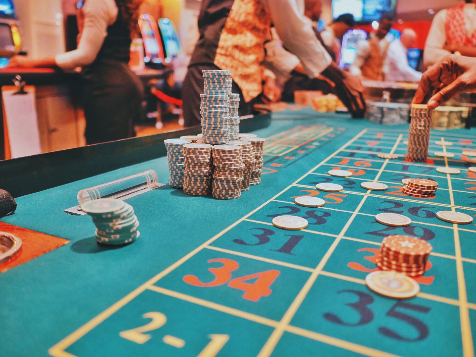 A poker table filled with colorful poker chips creating a vibrant and enticing display.