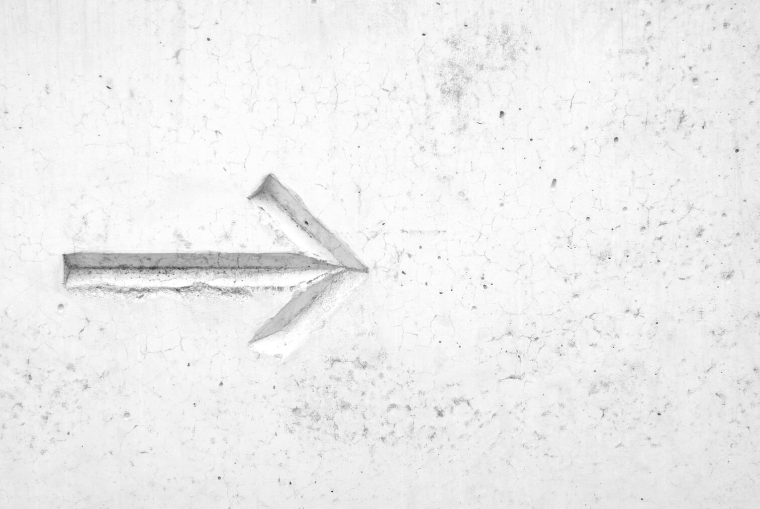 Arrow sign on a white wall