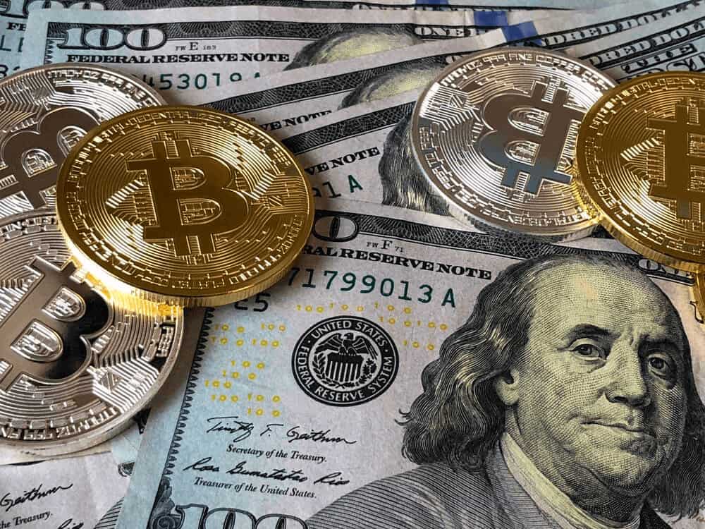 Dollars, silver and gold coins with Bitcoin symbols